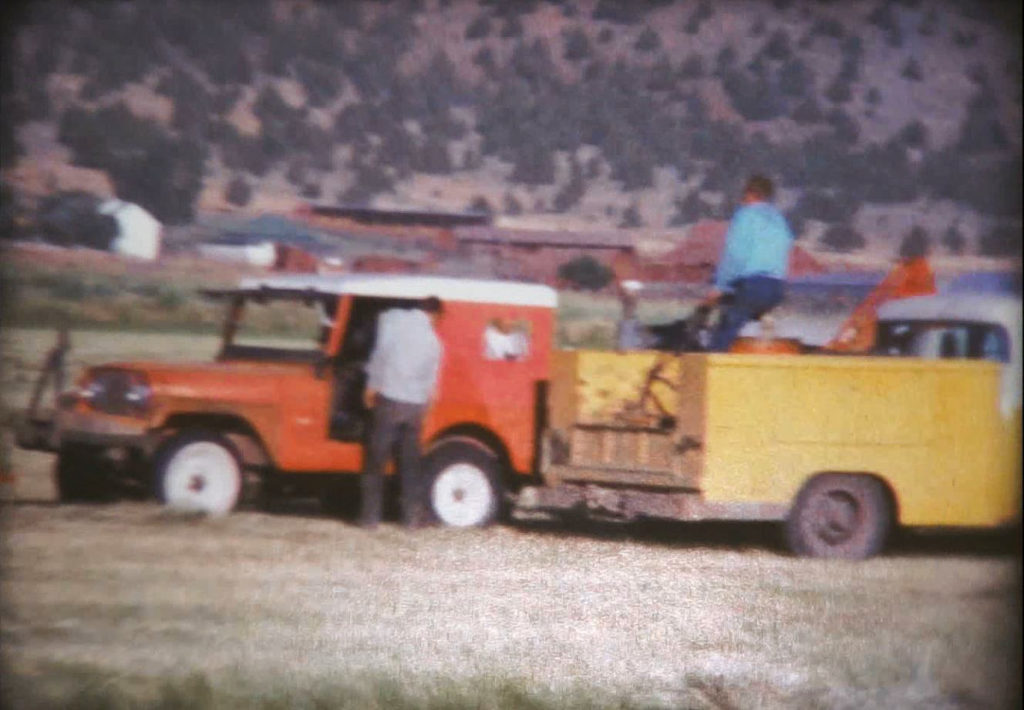 Red Jeep and yellow truck