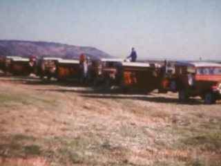 Jeeps towing hay balers in a row