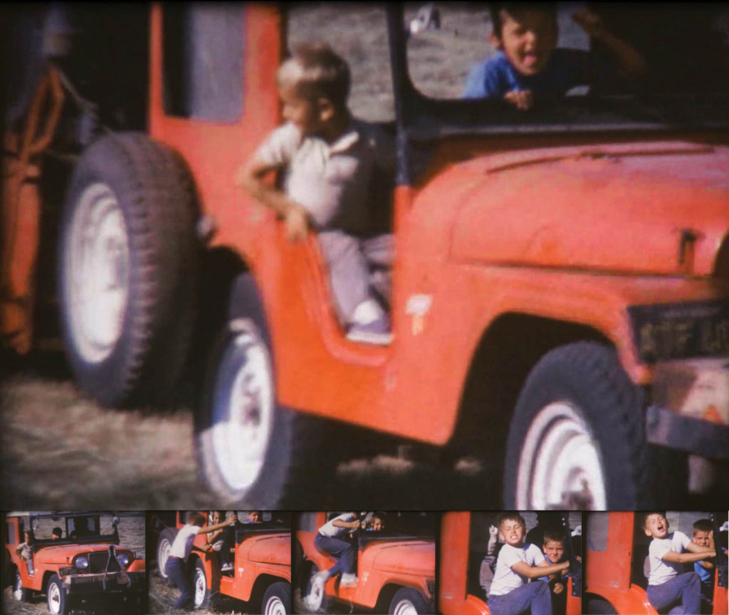 Yong boy jumps aboard a Jeep pulling a hay baler